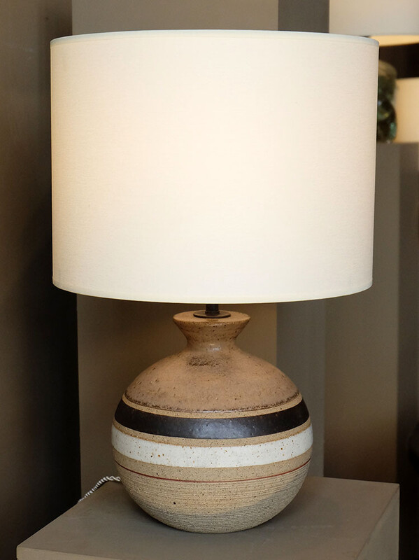 a pair of ball shaped white red and earth color frieze Bruno Gambone lamps